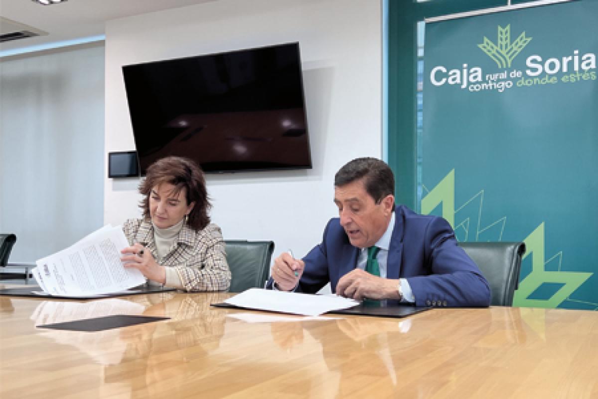 Imagen en la que firman el convenio Carlos Martínez, presidente de Caja Rural, y Reyes Juberías Hernández, en calidad de presidenta de la Asociación Cultural Soria Edita.